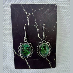 Fort Denaud Beard and Skin oval drop earrings featuring green snake-skin pattern cabochons in scalloped silver settings.