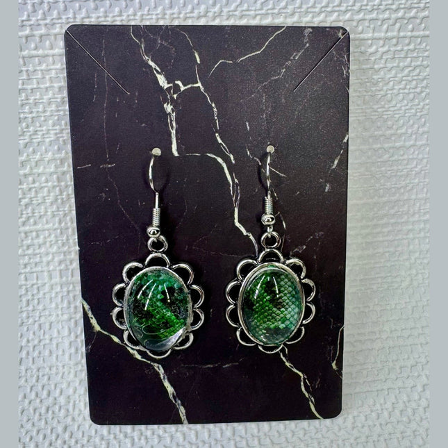 Fort Denaud Beard and Skin oval drop earrings featuring green snake-skin pattern cabochons in scalloped silver settings.