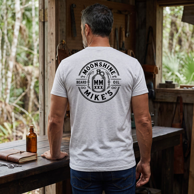 Fort Denaud Beard and Skin grey cotton t-shirt with Moonshine Mike's Beard Oil logo printed on the back