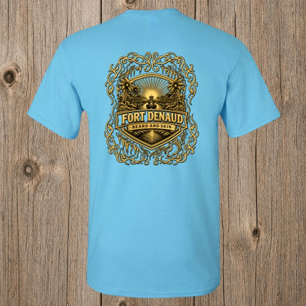 Fort Denaud Beard and Skin sky blue cotton t-shirt featuring a detailed gold and black badge graphic on the back