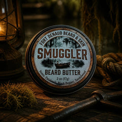 Fort Denaud Beard and Skin Smuggler beard butter in a 2oz tin with rustic swamp-themed label on a wooden table.