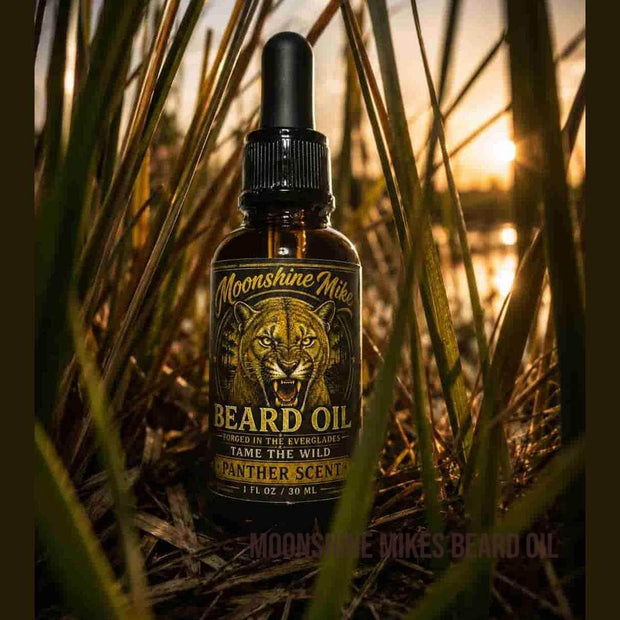 Moonshine Mikes Beard Panther Scent Beard Oil bottle with brushes and grooming tools in a stylish setting.
